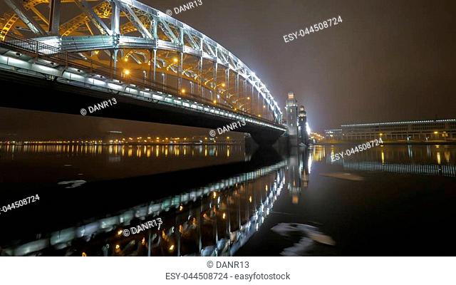 Illuminated Peter the Great Bridge across Neva River in night Saint Petersburg, Russia