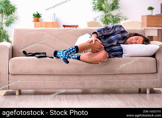 Young injured man suffering at home