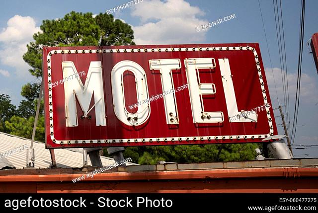 A vintage red motel sign on an old building in Texarcana, USA