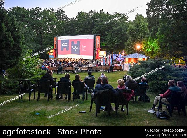 13 June 2021, Berlin: Numerous audience members sit during a late-night screening at the Friedrichshain open-air cinema during the premiere of ""The World Will...