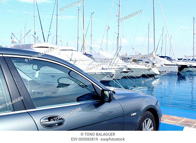 luxury car and yacht sailboats on Spain marina