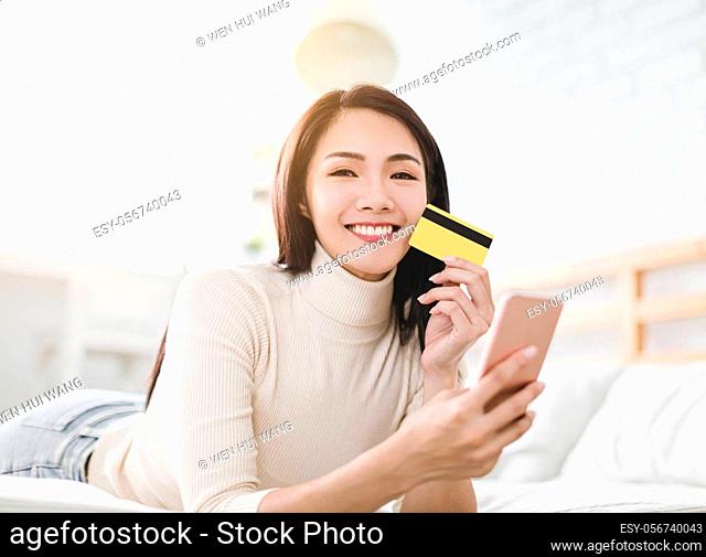 young Woman shopping online with credit card and smart phone