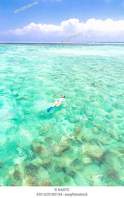 woman snorkeling in turquoise blue sea