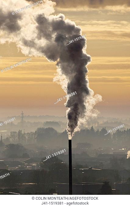 Chimney spews smoke, winter dawn from Port Hills, Christchurch, Canterbury, South Island, New Zealand