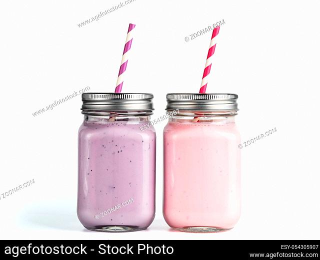 Strawberry and blueberry smoothie in mason jar glass. Isolated on white with clipping path