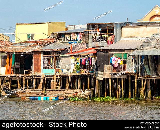 Shacks on stilts alog the Hau River in the Mekong Delta - Can Tho, Vietnam