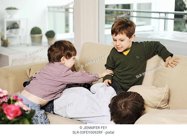 Boys playing on the sofa