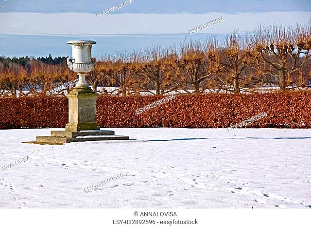 Empty urn as decoration in the park in winter