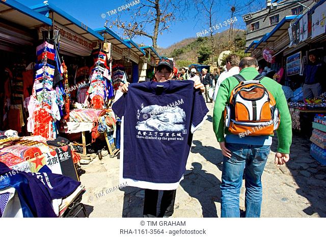 Tourists walk past souvenir tee shirt stating I have climbed up the The Great Wall, in Mutianyu, north of Beijing