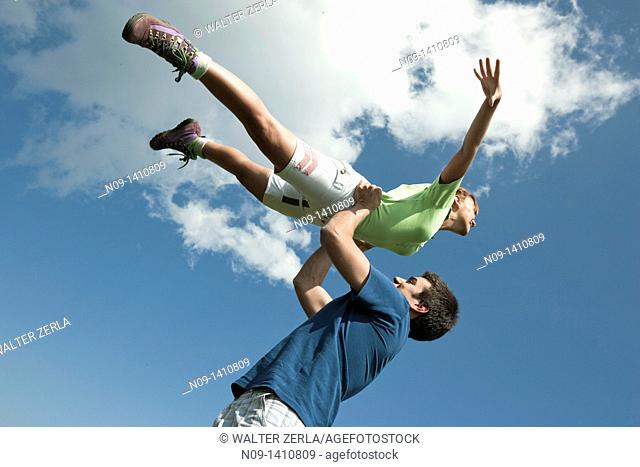 Girl held aloft flying