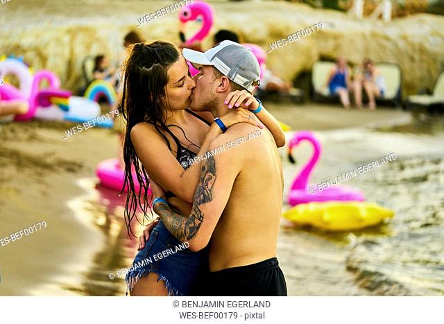 Greece, Crete, passionate lovers kissing at beach party