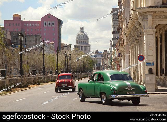 Vintage American cars used as taxis in front of the colonial buildings at Paseo del Prado with Capitolio at the background in Center Havana, La Habana, Cuba