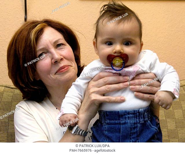 55-year-old mother Annegret Raunigk poses with her daughter Lelia on the 3rd of November in 2005. It is her 13th child and was fathered and born naturally