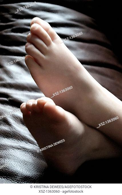 A child's bare feet in the light with effects