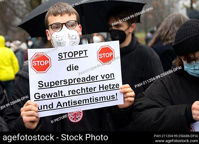 04 December 2021, Hessen, Frankfurt/Main: Participants of a counter-rally protest against a demonstration taking place at the same time