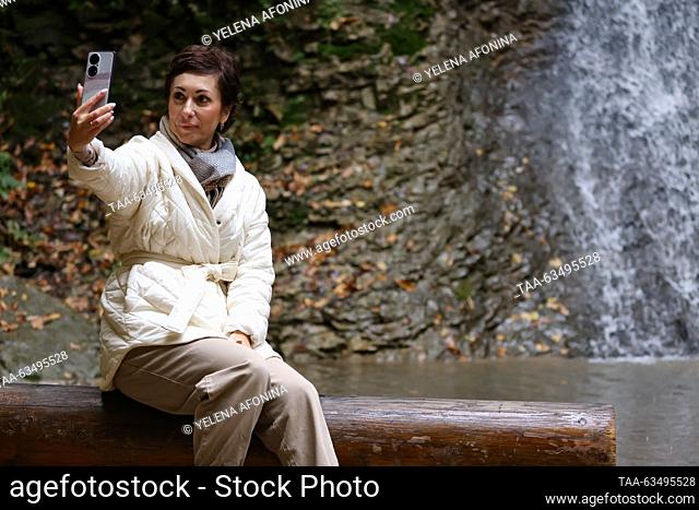 RUSSIA, GROZNY - OCTOBER 17, 2023: A tourist makes a selfie while visiting Nikhaloy Waterfalls in the Shatoy District. Yelena Afonina/TASS