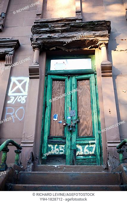 Dilapidated brownstone is for sale and awaiting restoration, in Harlem in New York