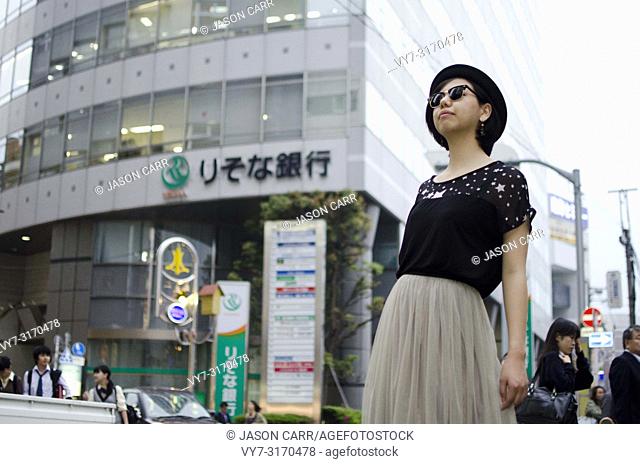 Japanese Girl poses on the street in Machida, Japan. Machida is an area located in Tokyo