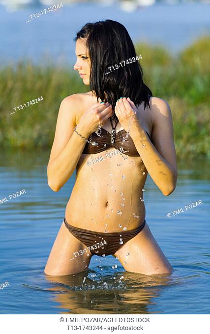 Young woman is cooling herself with water