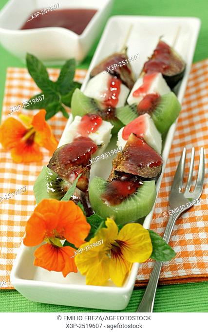 Skewers with fruit and flowers.