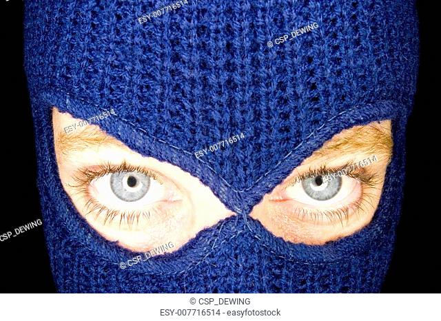 A stock photograph of an attractive woman wearing a balaclava