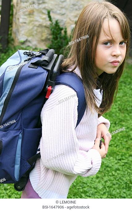 10-year-old girl. Illustration of back pain related to carrying a too heavy school bag
