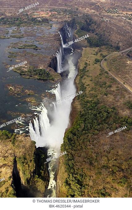 Aerial view of the Zambezi River and the Victoria Falls, in the foreground the Main Falls in Zimbabwe, behind the Rainbow Falls and the Eastern Cataract in...