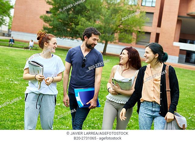 Students walking on campus lawn