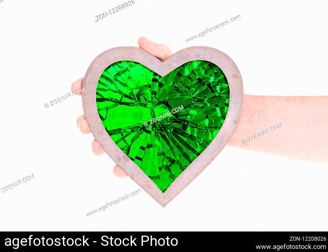 Adult holding heart filled with a large green ruby - Isolated on white