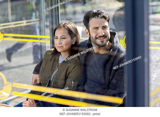 Couple waiting on bus stop