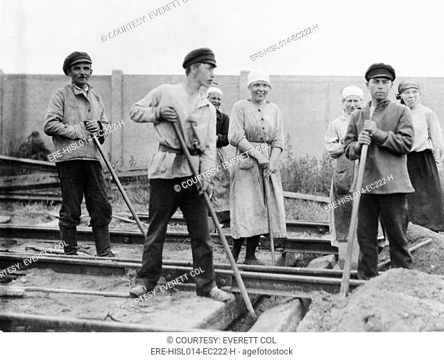 Russian men and women railroad track workers on the job in Petrograd, 1922. The Bolsheviks promoted the ideal of women's equality, a novel idea at the time