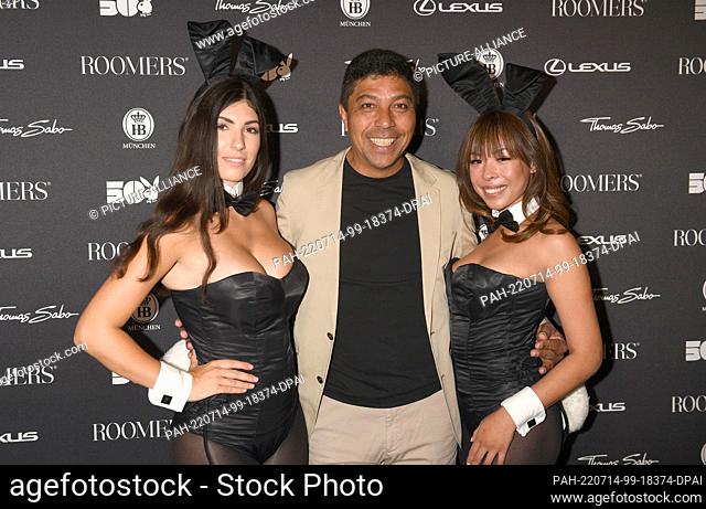 13 July 2022, Bavaria, Munich: Soccer player Giovane Élber shows off with Playboy bunnies at the ""50 Years of Playboy Germany"" anniversary party in the...