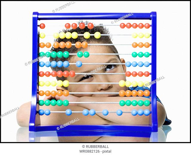 Close-up of a boy leaning in front of an abacus