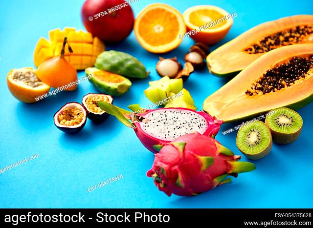 different exotic fruits on blue background