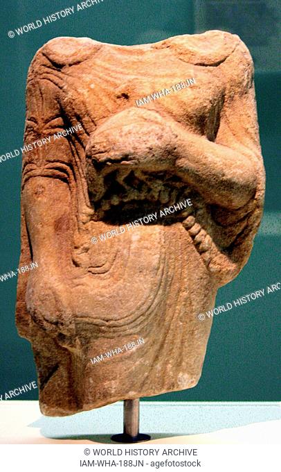 Kore (girl) holding a bead as an offering Marble, made in Ionia. From Theangela, Karia, made about 525-500BC. In Archaic Greek art the successful treatment of...