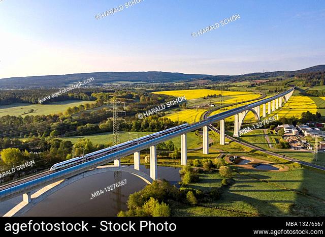 ICE, longest bridge in Thuringia (1681 m long, 48 m high), fields, blooming rape, high-voltage pylons, power line, backlight, aerial photo
