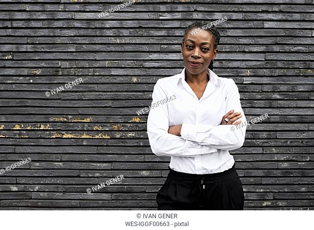Portrait of smiling businesswoman wearing white shirt
