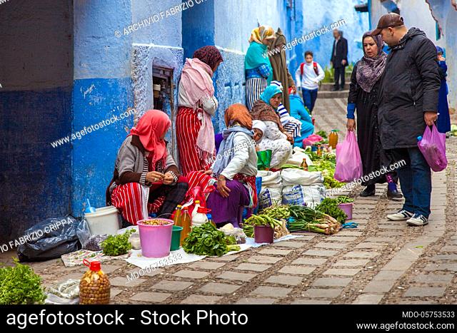 Women sell the products of their earth, fruit and vegetables, at the market in a street of Chefchaouen, April 2018