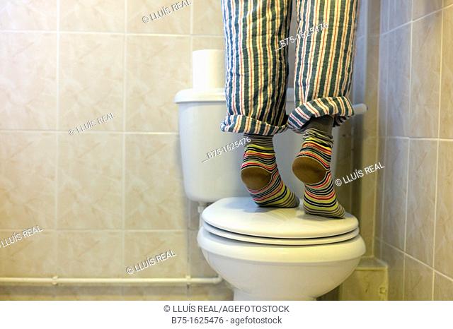 Person standing on toilet
