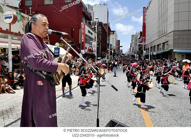 Naha, Okinawa, Japan: Okinawan singer and sanshin player Hidekatsu performing his hit 'Mirukumunari' at the opening ceremony of the 10