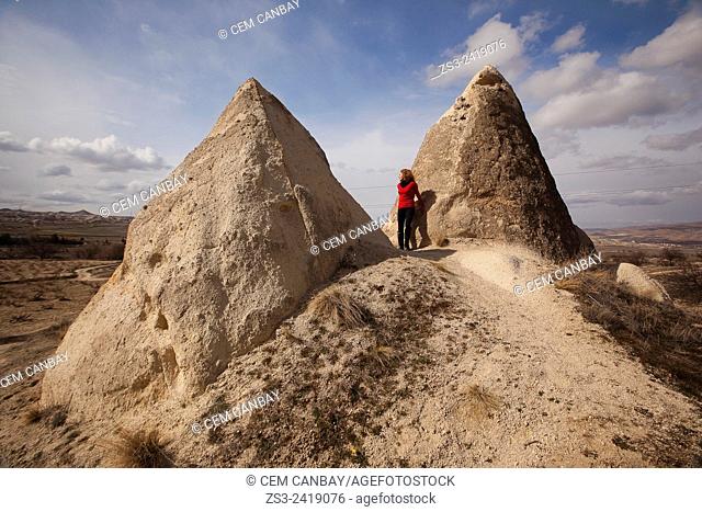 Woman near the fairy chimneys in Cavusin, Cappadocia Region, Nevsehir, Central Anatolia, Turkey, Europe