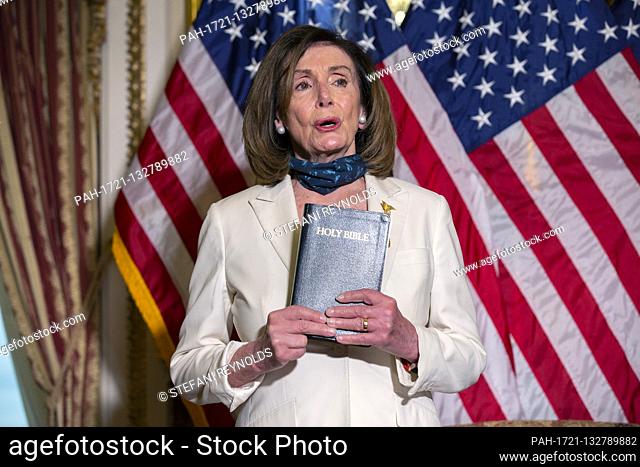 Speaker of the United States House of Representatives Nancy Pelosi (Democrat of California) holds the Bible following a bill enrollment ceremony for the Uyghur...