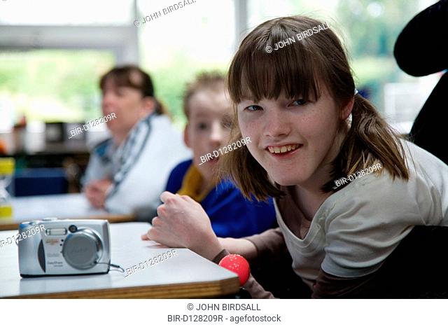 Physically disabled girl learning how to use a camera