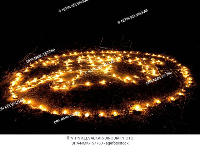 Lighting of lamps for celebrating Tripurari Purnima or Tripuri Poornima or Dev Diwali Deepostav at Mandapeshwar caves ; Borivali ; Bombay Mumbai ; Maharashtra ;...