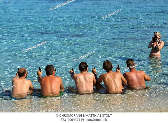 Five men sit in the sea