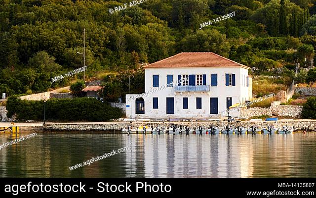 greece, greek islands, ionian islands, kefalonia, fiskardo, morning mood, partly cloudy sky, large white house with a red tiled roof
