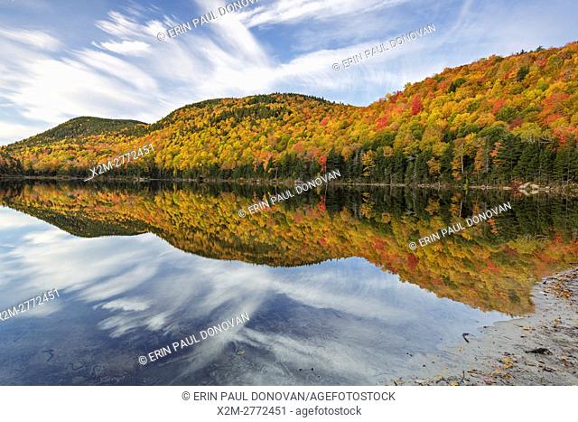 Reflection of autumn foliage in Upper Hall Pond in Sandwich, New Hampshire USA during the autumn months