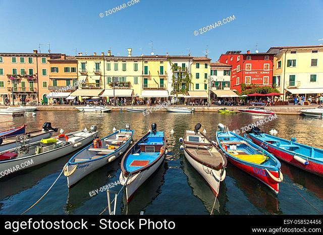 LAZISE, ITALY 16 SEPTEMBER 2020: Dogana Veneta and Porticciolo in Lazise, in Italy with colored boats