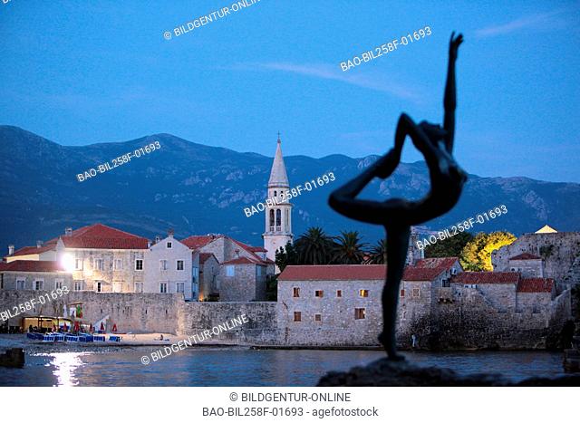 The Old Town with the church Sv. Ivan Krstitelji of Adriatic city of Budva with many new Appatementhausern in Montenegro in the Balkans at the Mediterranean Sea...