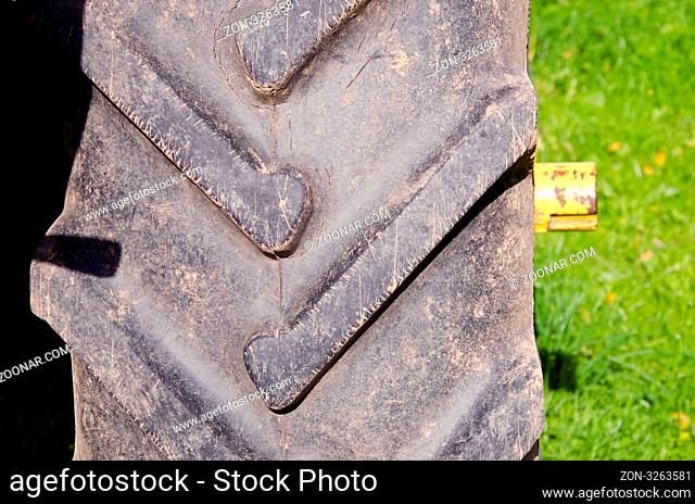 Tractor tire protector closeup background. Agricultural machinery part fragment